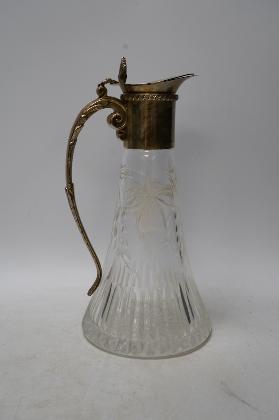 A brass mounted two bottle tantalus and three glass decanters / jugs, largest 32cm high. Condition - fair